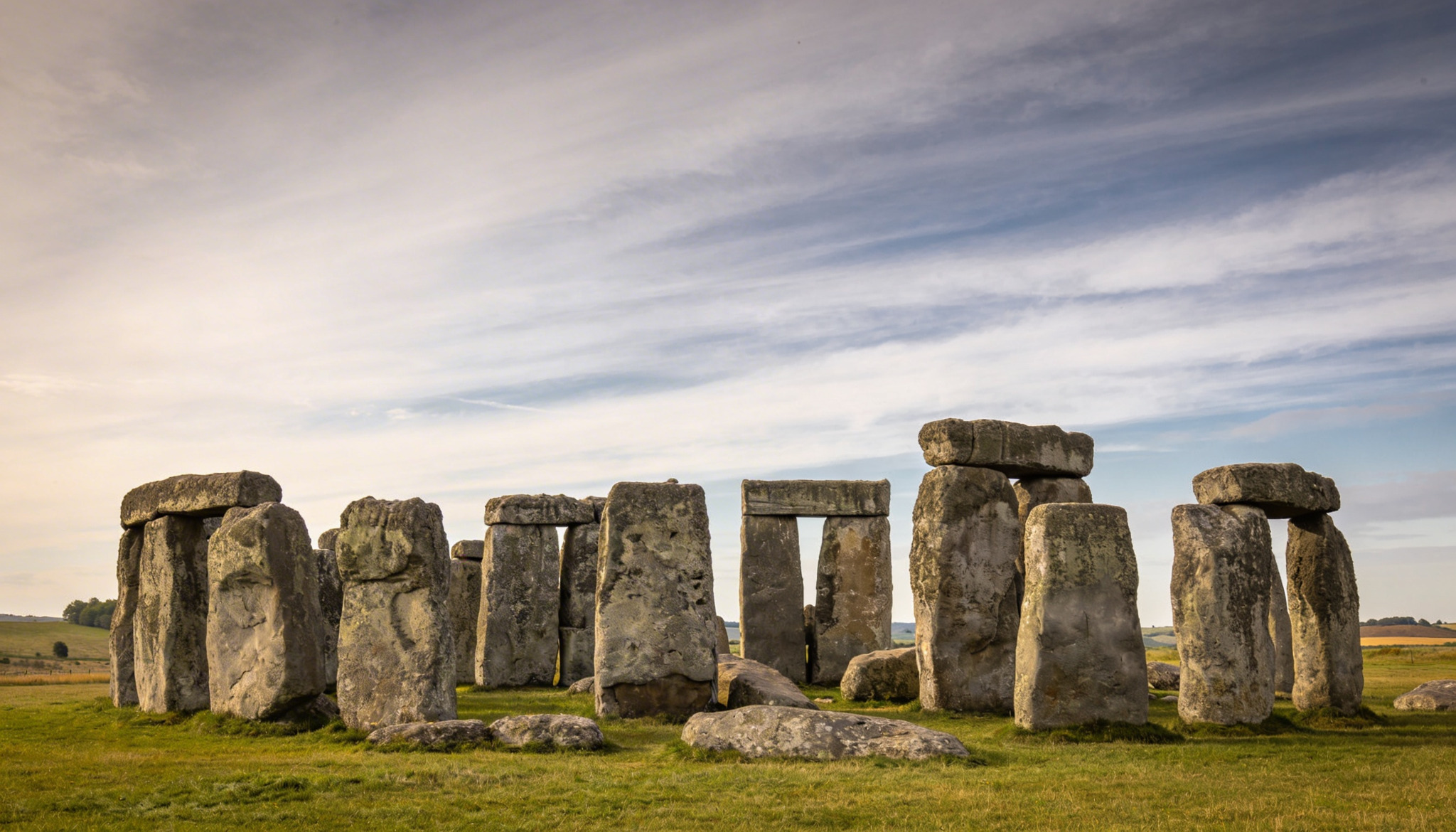 Stonehenge in Wiltshire, England, in soft daylight with open grassland and wide sky